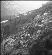 Landslide in Maggia valley; rubble blocking street; 1950.