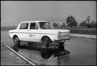 Anti skidding school; car on wet street 1971.