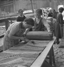 Making rag rugs with remnants, 1940.