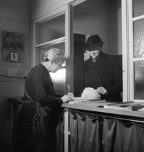 Woman selling embroideries, 1941.