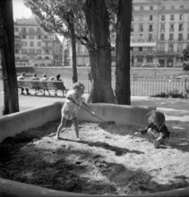 Genf: Ile Rousseau, children playing in sandpit; 1949.