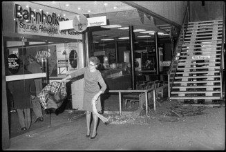 Bomb attack in Zurich mainstation; woman shaking out broken pieces of her clothes 1971.
