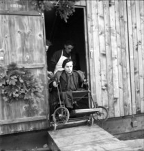 Disabled boy in wheelchair, 1945.