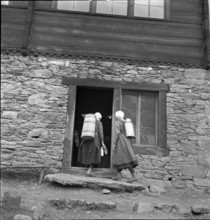 Lötschental, women carrying milk churn, 1941.