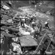 Avalanche in Andermatt; men doing clearing work after thaw; 1951.