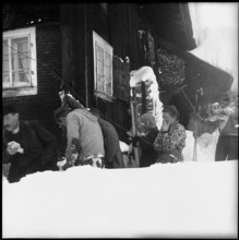 Avalanche in Spiringen, Schächen valley: people mourning for avalanche victim;  1954.