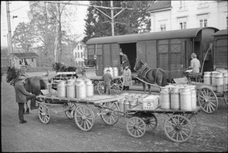 Milk cans; loading in goods train; 1941.