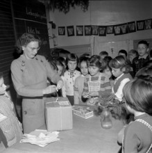 Teacher cording a parcel for children in Hungary, Zurich 1956.