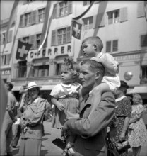 Zurich, National Holiday celebration, man with two children;  1943.