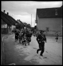 Auxillary fire brigade: women dragging hose cart, 1941.
