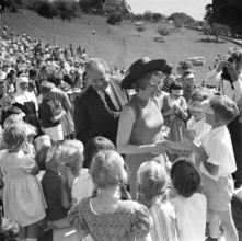 The Prince and his wife surrounded by children.