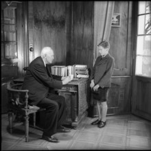 Teacher and Male Teenager in Community Home.