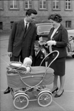 Woman with family, stroller and voting card 1963.