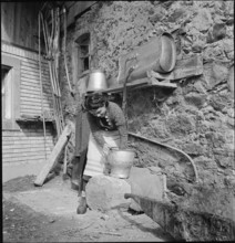 WW 2: farming camp; volunteer doing cleaning work, 1939.