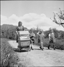 Mother and children walking, 1941.