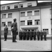Women soldiers drilling in front of barracks Fribourg 1962.