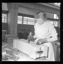 worker fills asbestos cement in a window box form.