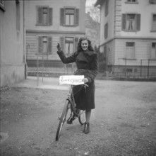 Woman advertising hard-wearing type of tyre; 1943.