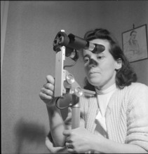 Woman with colposcope for the gynaecological check-up, Geneva 1951.