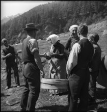 Cheese donation in the Turtmanntal valley, Switzerland, 1940.