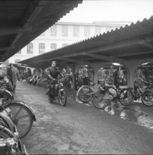 Man on bike with motor, 1958.
