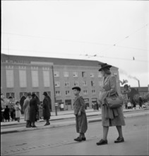 Woman and child strolling before exhibition hall; 1942.