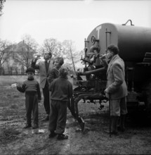 Refugees from Hungary drinking water out of tanker 1956.