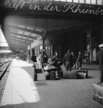 Passengers waiting for the train at Basel station, 1951.