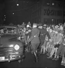 People crowding round car with Henri Guisan, Neuchatel 1949.