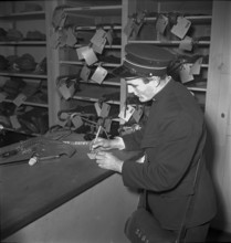Conductor in lost property office, Oensingen 1949.
