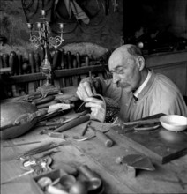 Geneva: artist blacksmith in his studio; 1943.