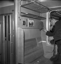 Coductor finding military cap in railroad car, Oensingen 1949.