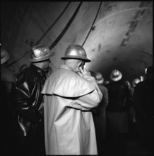 Tunnel breakthrough: man keeping his ears shut, Grand-St-Bernard 1962.