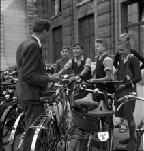 Basle, boys offer cleaning of bicycles; 1941.