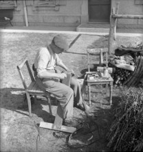 Illens FR: farmer doing carpentry; 1952.
