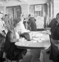Jungfraujoch 1942: tourist writing post card.