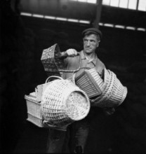 Man with sewing baskets, 1945.