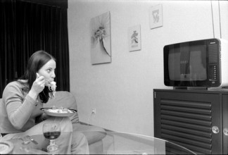 Woman eating in front of TV, 1973.