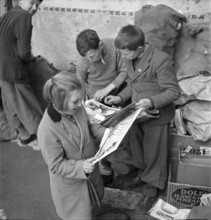 W K 2: war economics; young people collecting material to be recycled.