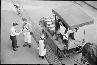 Milkman serving customers; 1941.