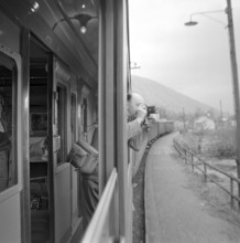 Passenger taking photos in the Gotthard railway, 1957.