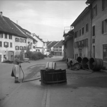 Hallau; woman cleaning wooden tub; 1958.