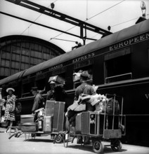 Porters with luggage cars before departure of the Northern Express, 1947.