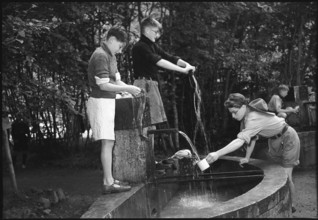 English boy scouts drinking and doing laundry, 1950.