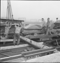 Construction worker demolishing a railway bridge 1941.