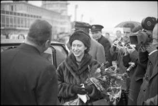 Margaret with the british consul general James Walsh (left); on her way to Davos.