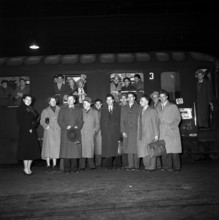 Group of workers travelling to the USA to share ideas and experiences posing for the photographer;