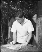 English boy scout doing laundry, 1950.