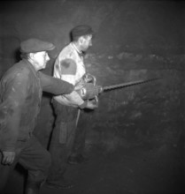 Herznach mine, workers prepare for blasting; 1952.
