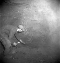 Herznach mine, miner prepares for blasting; 1952.